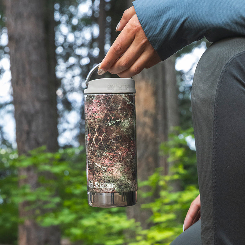 12oz-tkwide-with-cafe-cap-mossy-oak-t8 12oz_tumbler_mossyoak_rainbowtrout_hand_closeup_square.jpg