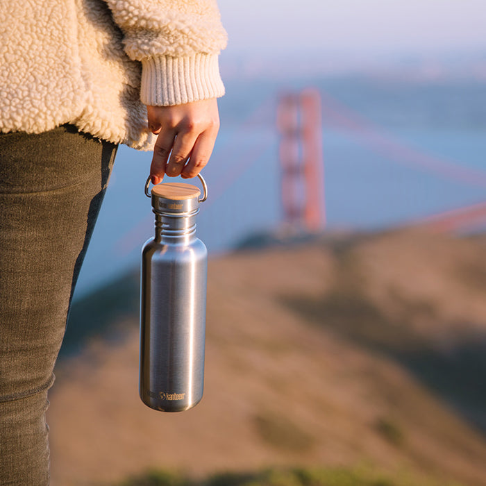 27oz-reflect-with-bamboo-cap-k2 K27SSLRF-BS-BAMBOO_reflect_bottle_bridge_lifestyle.jpg